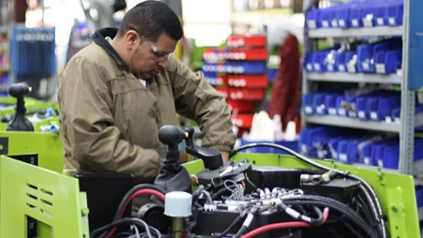 Technician repairing Clark forklift